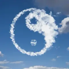 Symbol Yin Yang uformowany z chmur na tle błękitnego nieba.