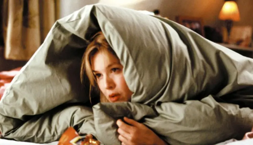 Bridget Jones ukrywa się pod kołdrą. Kto jest autorem popularnej książki "Dziennik Bridget Jones"? Helen Fielding.